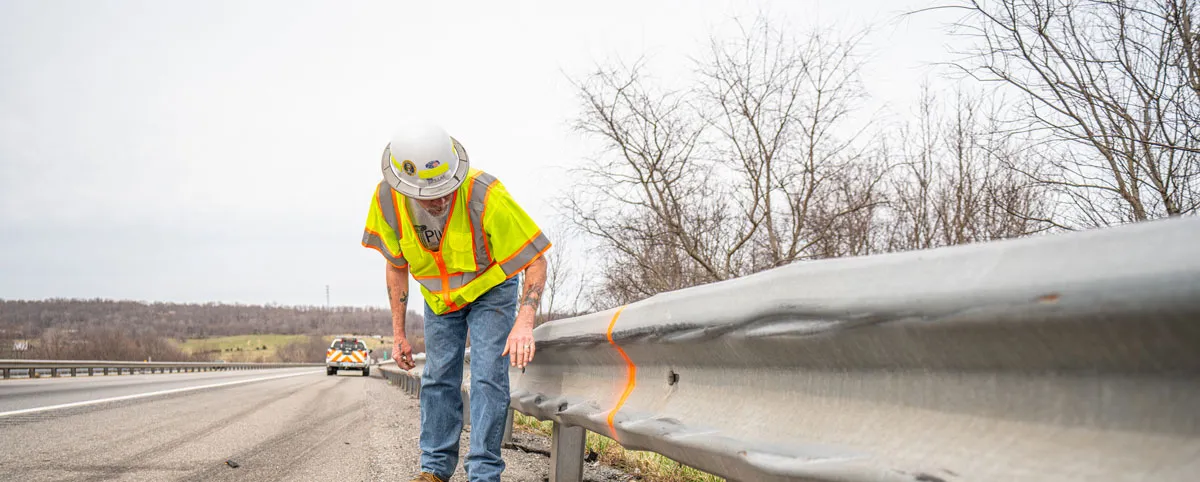 PILLAR Employee Inspecting Guardrail PILLAR Employee Inspecting Guardrail