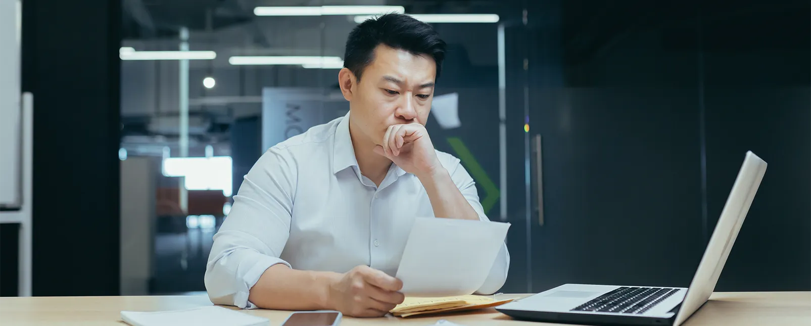 Man frustrated while reading over a request for proposal (RFP) Man frustrated while reading over a request for proposal (RFP)