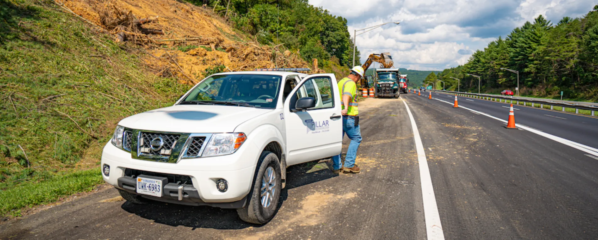 man and truck on side of highway man and truck on side of highway
