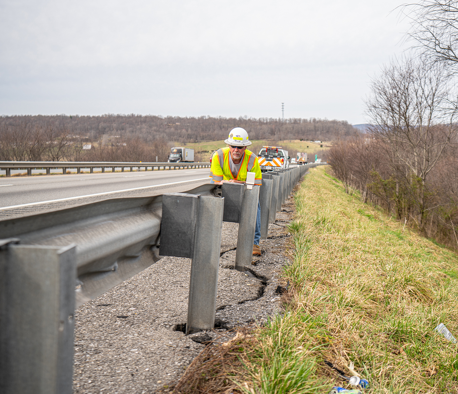 PILLAR Employee Inspecting Guardrail Damage
