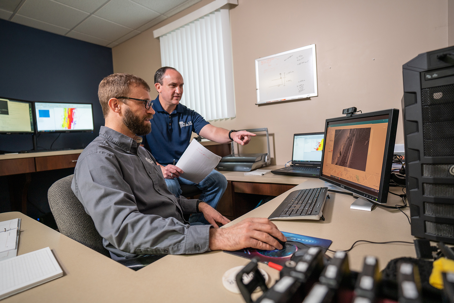 PILLAR Employees working at a computer