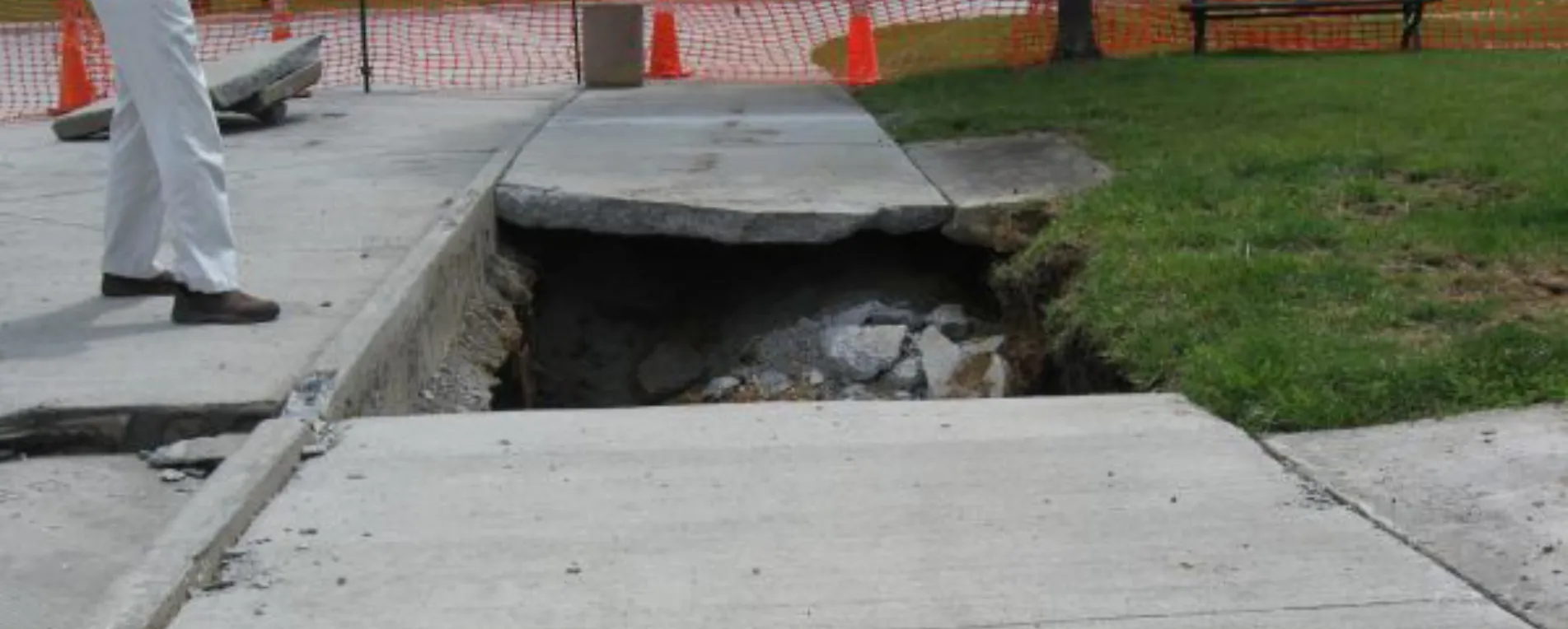 open sinkhole in a sidewalk open sinkhole in a sidewalk